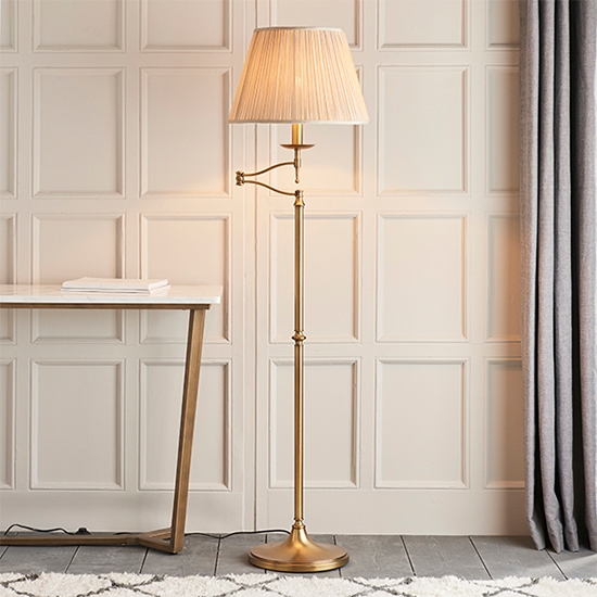 Stanford Swing Arm Beige Shade Floor Lamp In Antique Brass